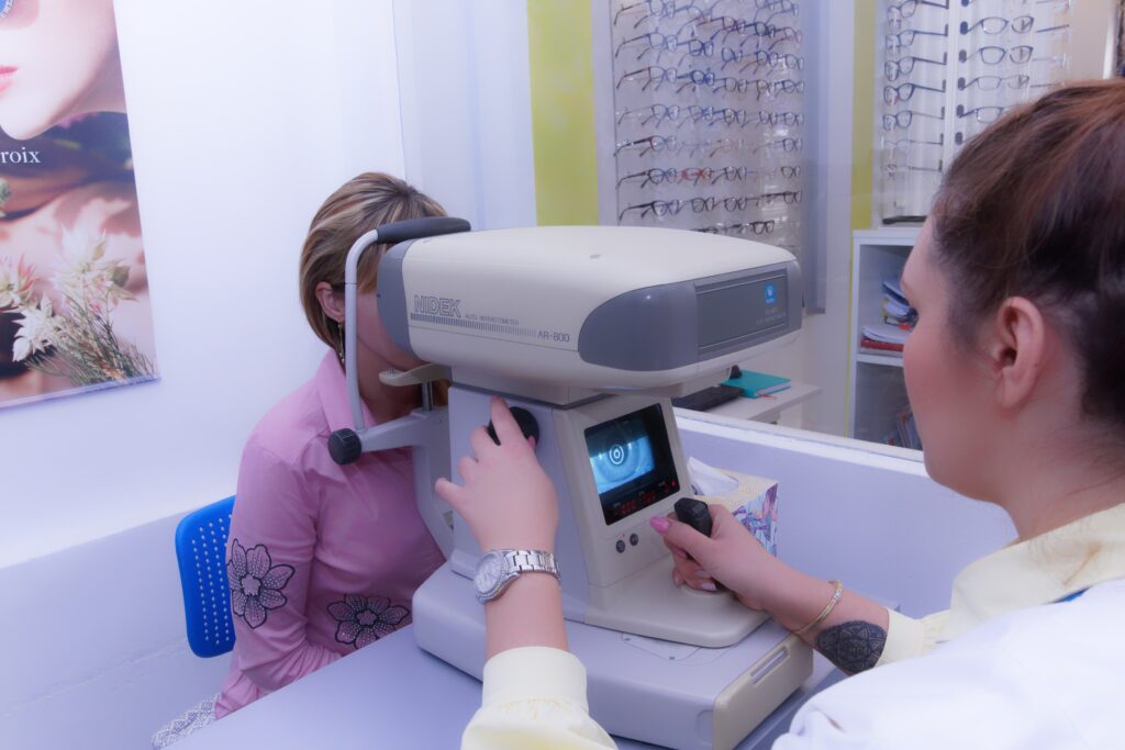 Optometrist performing an eye examination with an autorefractor