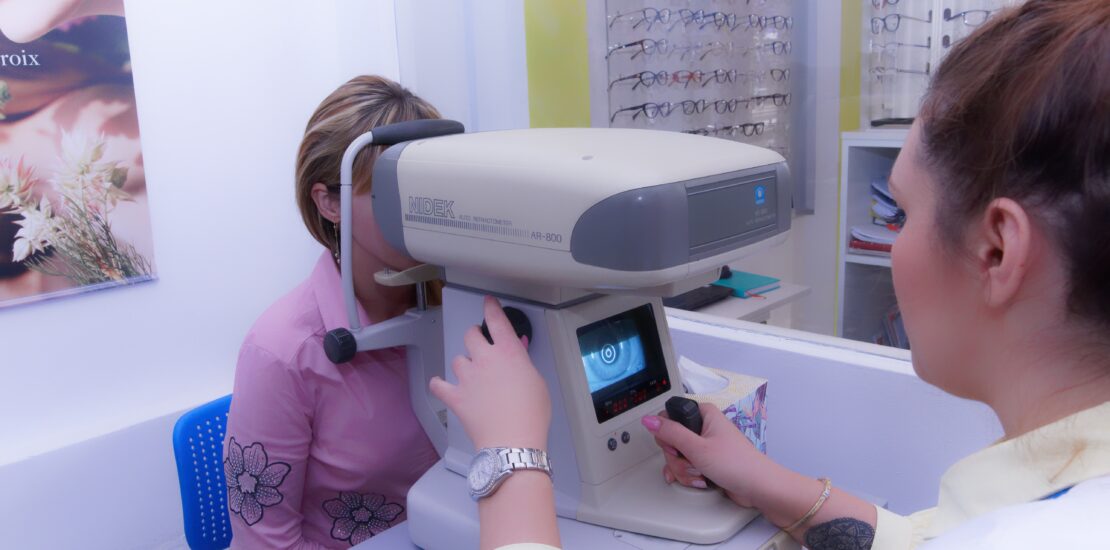 Optometrist performing an eye examination with an autorefractor