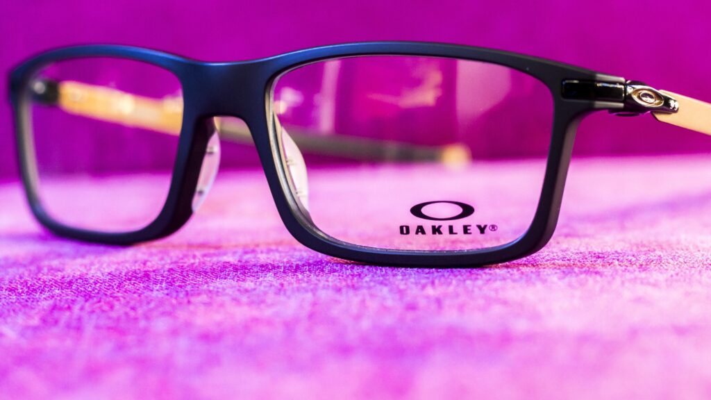 Eyeglass frame displayed against a pink background