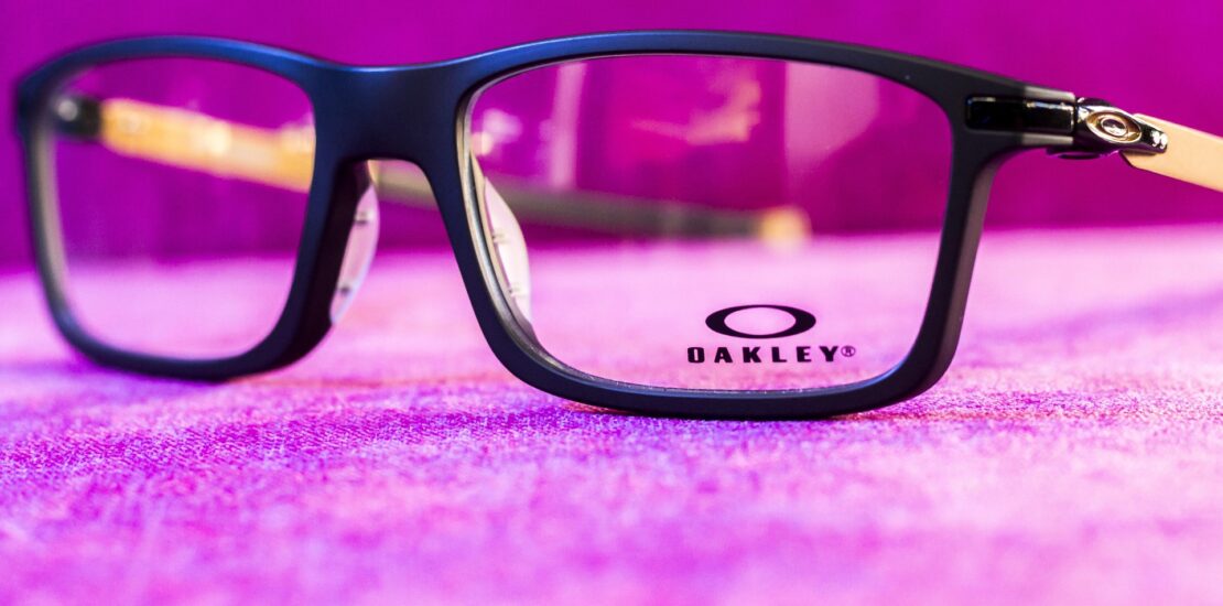 Eyeglass frame displayed against a pink background